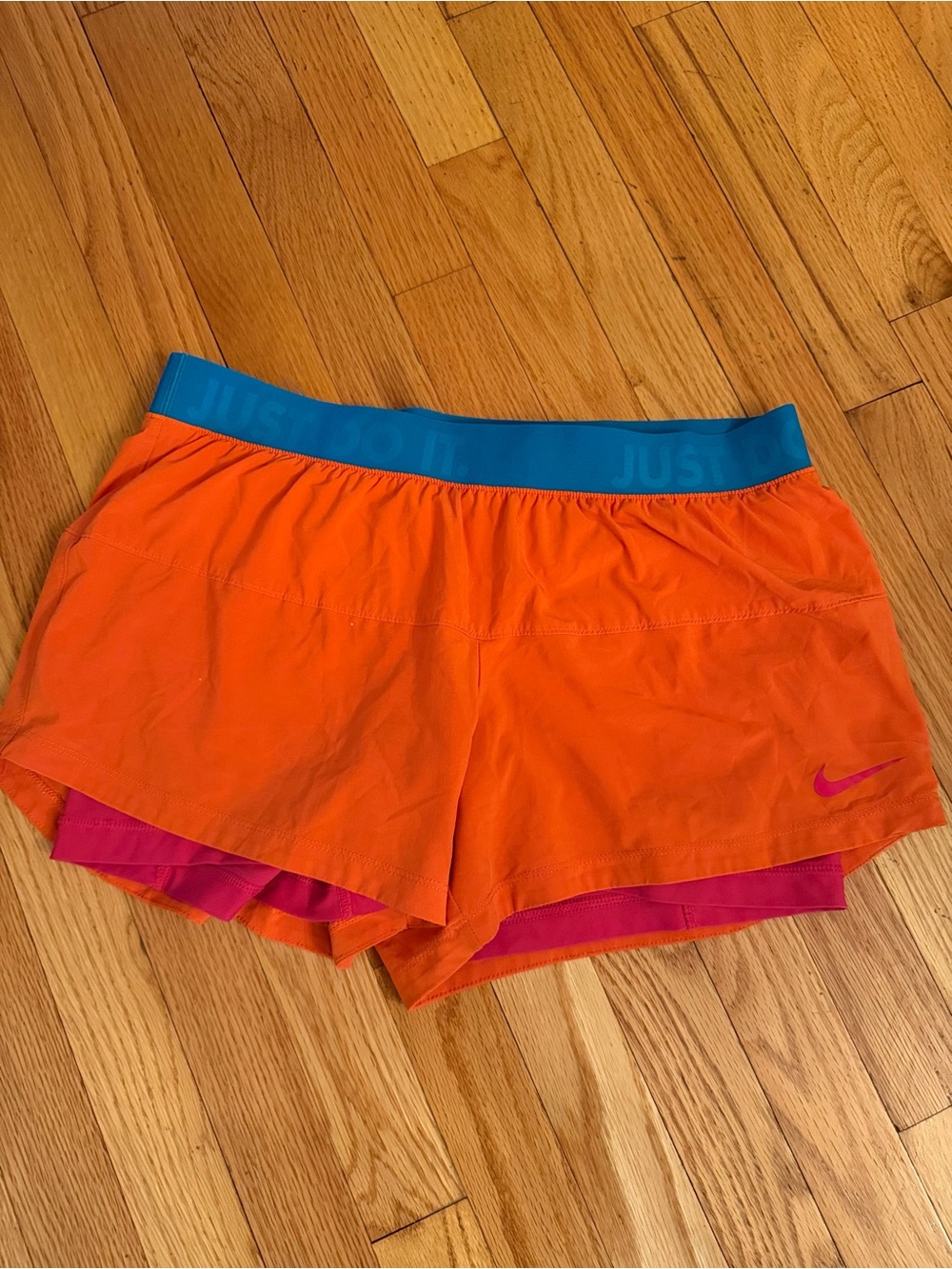 Nike Women’s Orange Athletic Shorts with Blue Waistband and Pink Liner